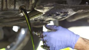 Dirty Motor Oil Being Drained