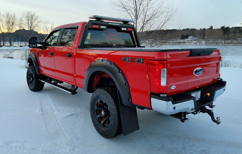 red pickup truck with open frame metal headache rack from magnum truck racks - shown with optional light bar across the top
