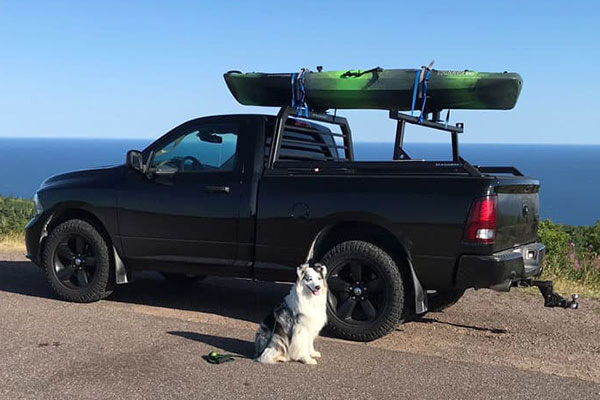 Pickup truck with Magnum headache rack and rear cargo rack with a kayak on top.