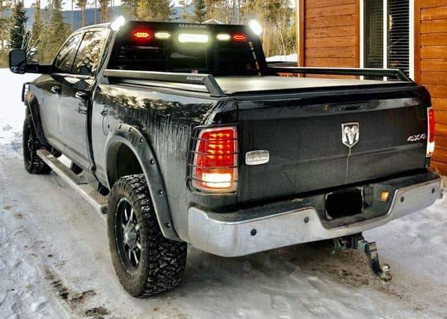 black pickup truck with lighted headache rack showing a magnum low pro model truck rack