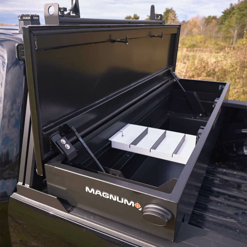 side quartering view of truck bed toolbox with open lid showing white inner tray - toolbox is empty