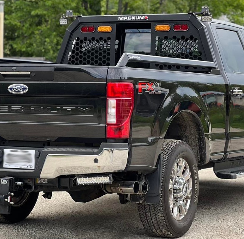 black ford pickup truck with honeycomb style magnum truck rack protecting the back window - the rack has a 72 inch extension tube mounted on top of it