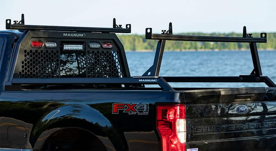 black ford pickup truck with magnum's rack pack combo package on it which includes a rear rack a headache rack an extension tube and bed rails