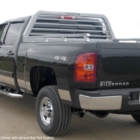 A black Chevrolet Silverado with a gray truck rack and bed rails